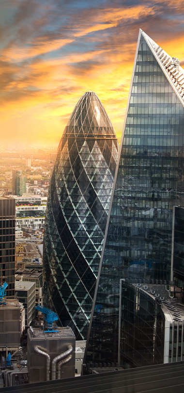city skyline during sunset with modern skyscrapers including the Gherkin and half a dozen other buildings showcasing architectural beauty 32-story buildings in view