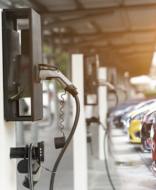 electric vehicle charging stations with multiple chargers and parked cars showcasing 20 fast charging options available