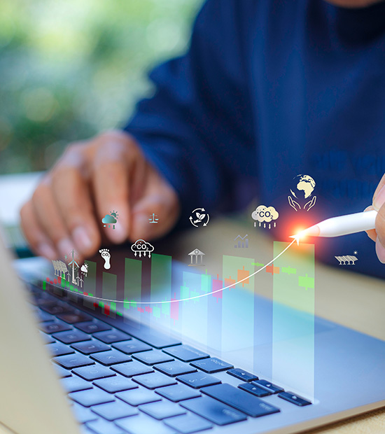 person using a laptop with digital graph and icons representing 29 environmental indicators showing growth and analysis