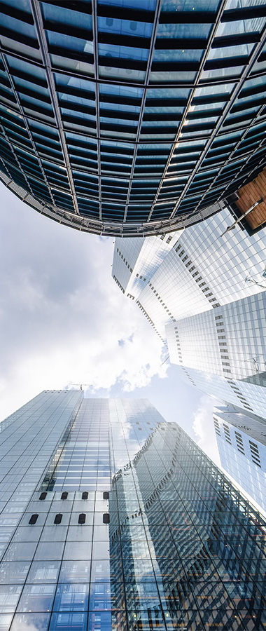 view of modern skyscrapers with reflective glass facades and a cloudy sky showcasing architectural design in an urban setting with six distinctive structures